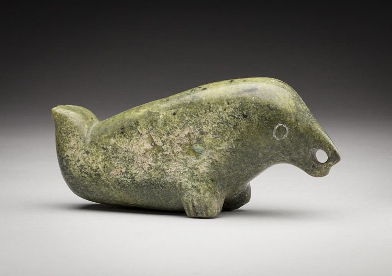 Latcholassie Akesuk, BIrd-seal transformation, c. 1965
2 1/2 x 5 1/4 x 1 1/4 in. (6.3 x 13.3 x 3.2 cm)
Ex Albrecht Collection
In true Latcholassie fashion, this carving is somewhat ambiguous in appearance. Although the overall form is that of a seal, its head is decidedly bird-like. The carvingâ€™s small size and beautiful finish lend this
creature an intimate quality that is not often found in Latcholassieâ€™s work.
03472-2